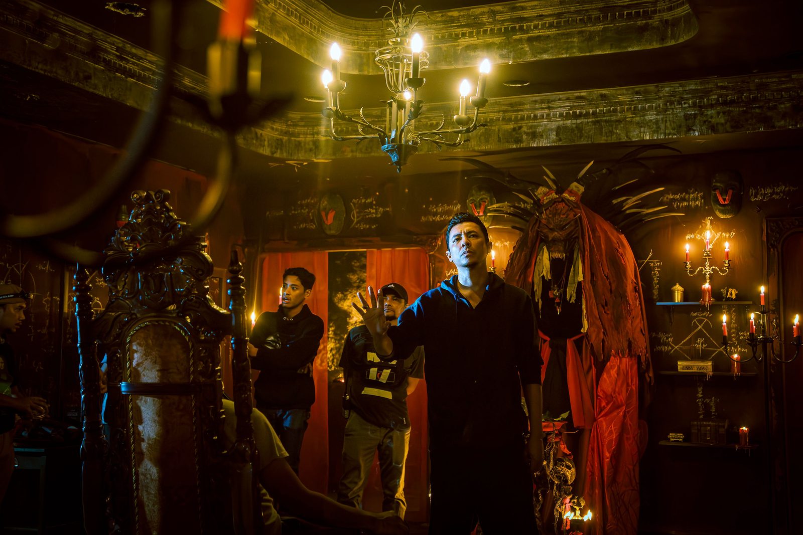 Crew blocking a scene on a candlelit interior set