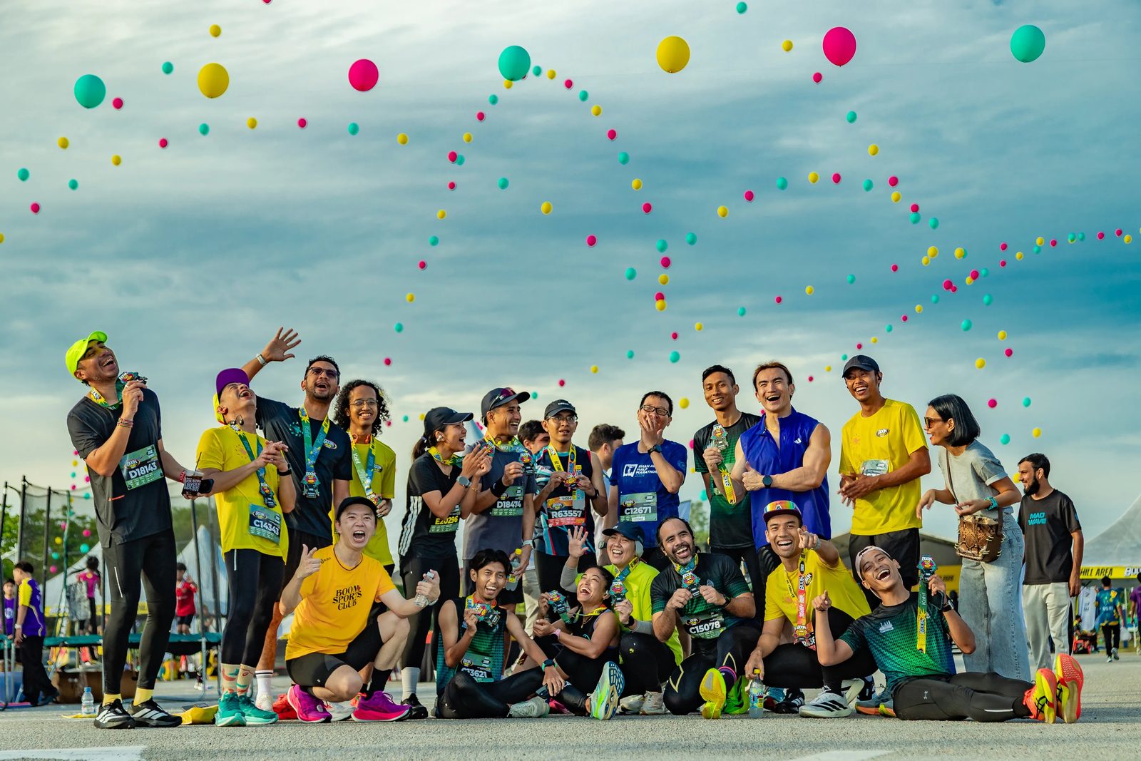 Participants celebrating with confetti at an outdoor daytime event