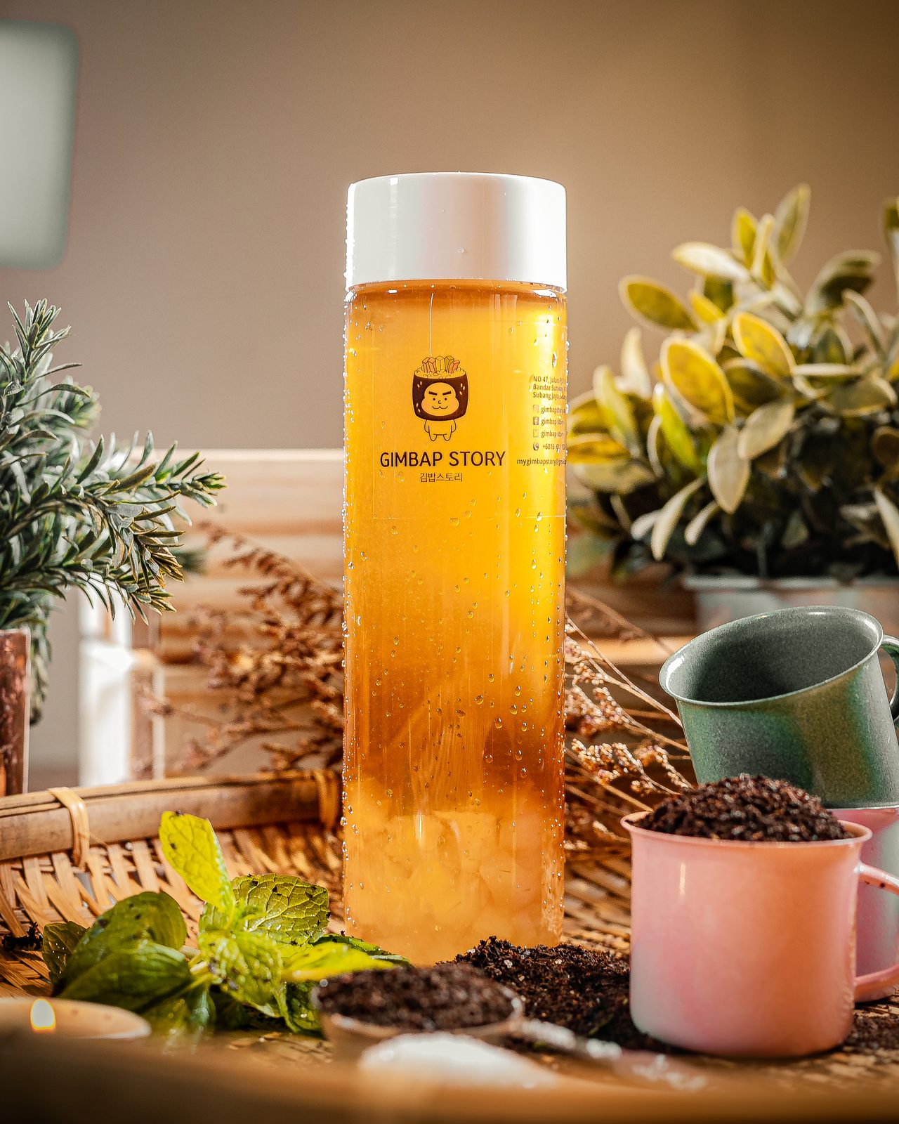 Bottled iced tea product shot with mint and dried botanicals