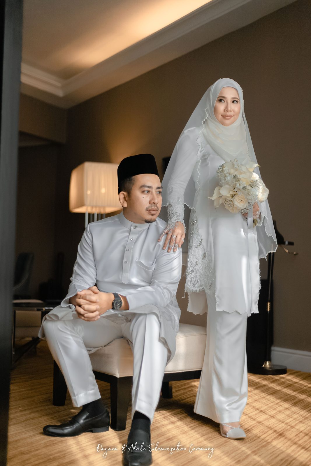 Couple in white attire photographed in a hotel suite