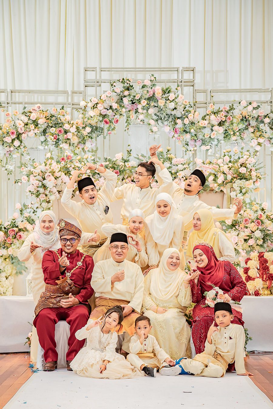 Extended family in traditional dress seated for a group portrait